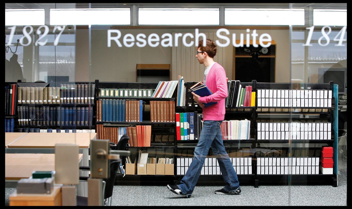 Photo of Research Suite and a Student walking past