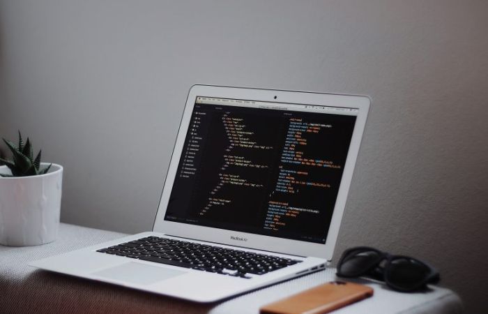 Laptop displaying coding language