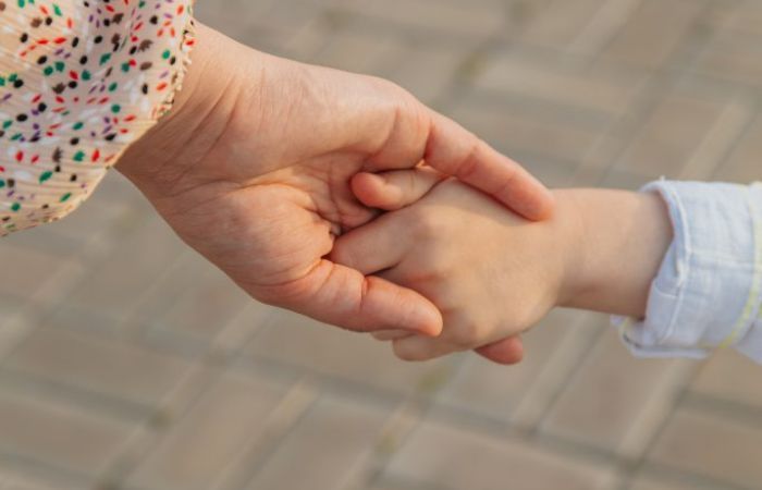 Mother and child holding hands