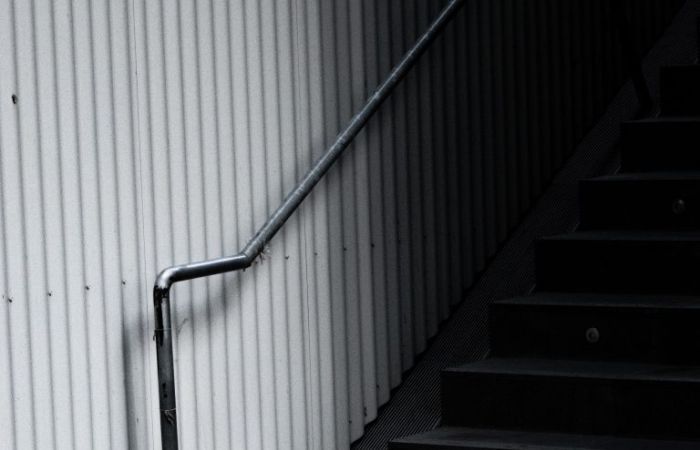 Steps and rail inside corrugated steel structure
